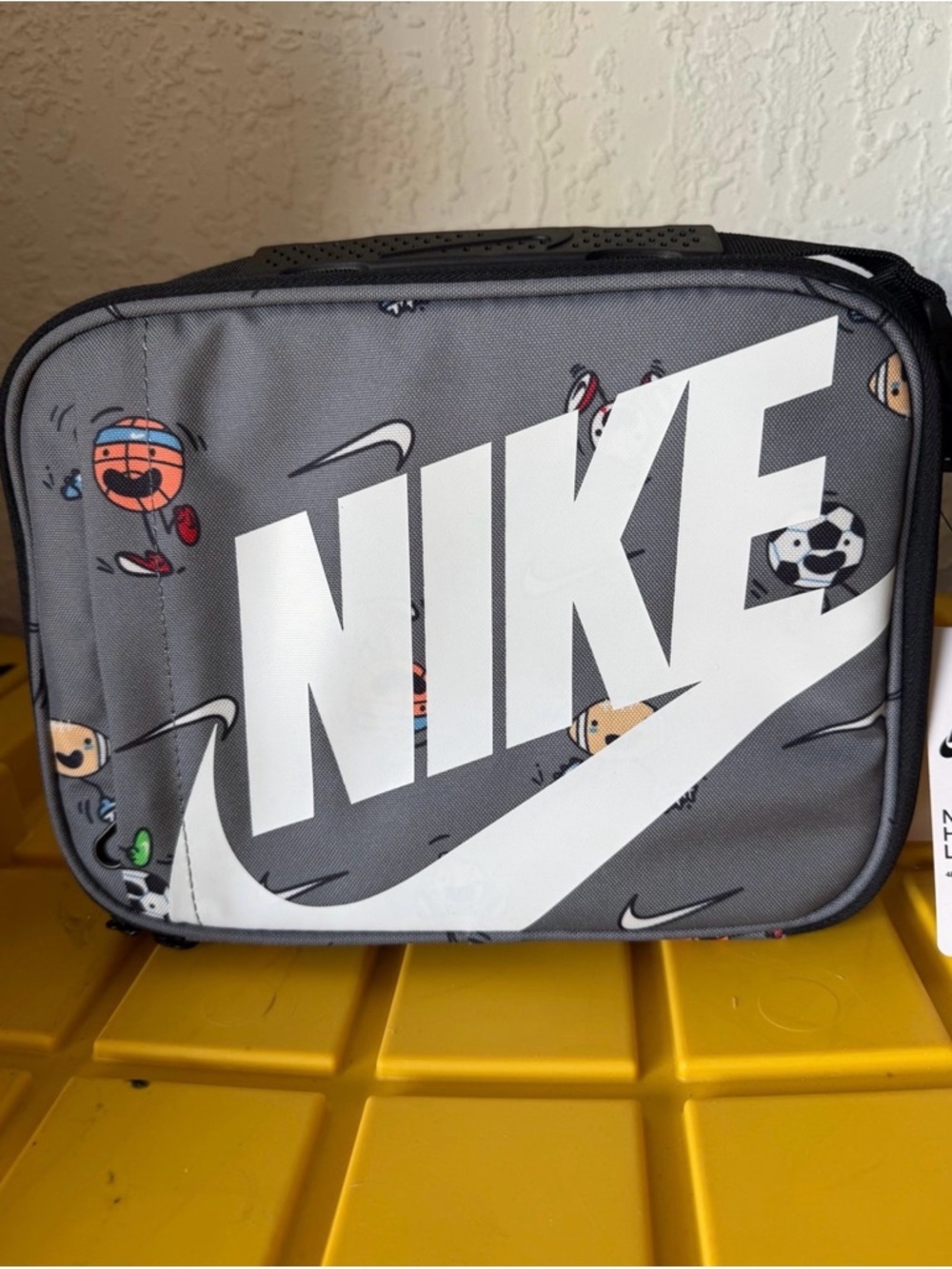 Nike Gray hard shell lunch box with White Logo and Sports Icons